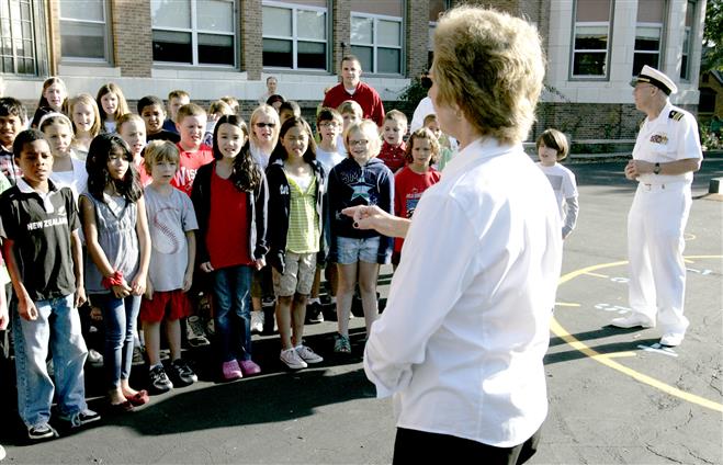 Music teacher Peggy Paar leads the Roosevelt School fifth graders in singing the "Star Spangled Banner" several years ago. Paar is one of five Wauwatosa teachers to receive a scholarship from the Suburban Woman's Club of Wauwatosa this year. File photo by C.T. Kruger.
