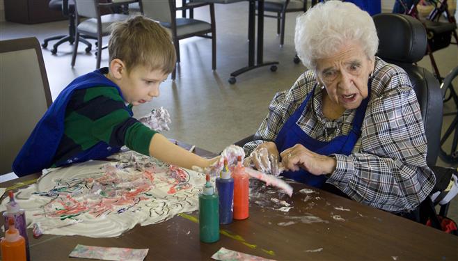 Five-year-old David Gerboth and Eileen Badtke create art work with shaving cream and dye in the Lutheran Home Friday, March 6. Having kids and adults interact is a benefit to both!
