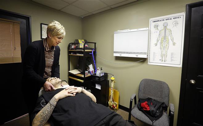 Dr. Corrine Kennedy works with patient Jilbelto Marcano Jr. in her North Avenue office in Wauwatosa.