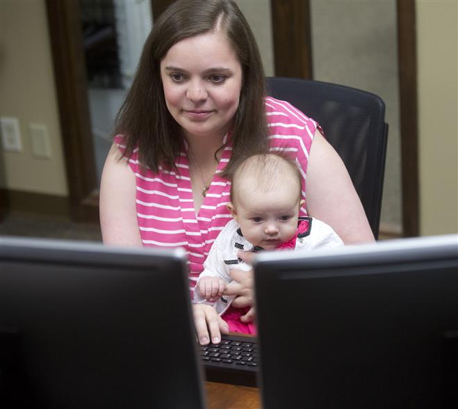 Alice Haugen sometimes works on her Internet design business at home. Other times, she brings her daughter, Rose, 3 months, to her husband’s office.