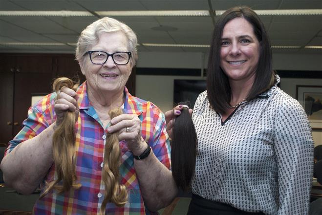 Deemed too short to donate more than 70 years ago, Suzanne Badten, 83, recently donated her hair to Locks of Love. Luther Manor President Stephanie Chedid (right) also donated her hair.