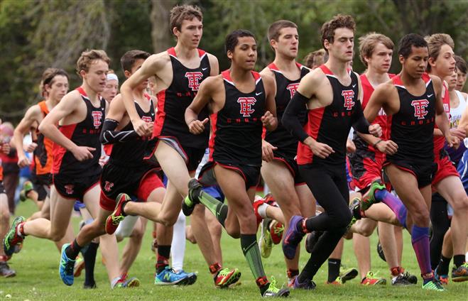 Members of the Wauwatosa East boys cross-country team run in a pack at the start of the 5,000-meter Purgold Invitational race at Sheridan Park on Oct. 3. From left are Jack Sveum, Faisal Bartlett (partially hidden), Sam Stelloh, Nathan Green, Paul Gagne, Sam Potter and Marquez Green.