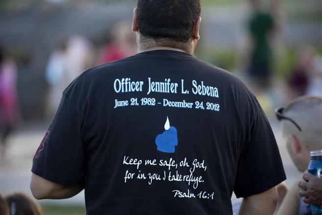 Off duty City of Wauwatosa Police Officer Joe Lewandowski listens to a live band in front of the Rotary Performance Pavilion during First Responder Fest in Hart Park Wednesday, July 17, 2013, in Wauwatosa, Wis.