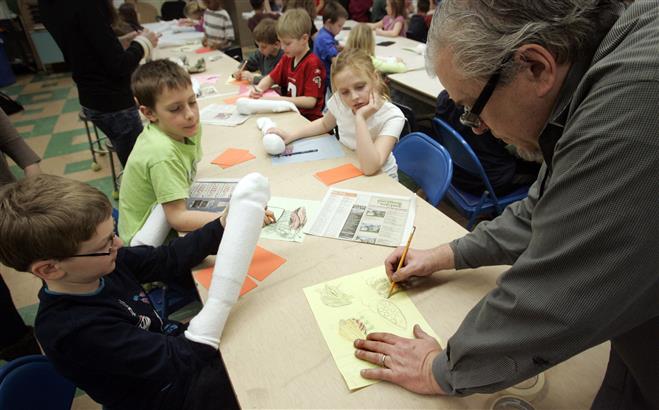 Tim Decker, a former "Simpsons" animator and UWM professor, works with third graders Aiden Vandre (left) Robert Becker and Makenzie Haar as they create bug puppets during a workshop at the Wauwatosa STEM School on March 8. Tim Decker, a former "Simpsons" animator and UWM professor, works with third graders Aiden Vandre (left) Robert Becker and Makenzie Haar as they create bug puppets during a workshop at the Wauwatosa STEM School on March 8.